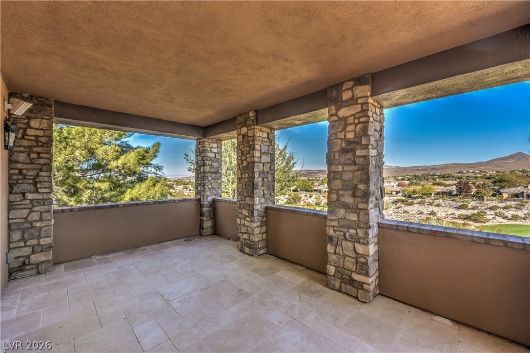 16 Anthem Pointe Court, Henderson, NV 89052 Stone pillars frame panoramic mountain views from this tiled covered patio.