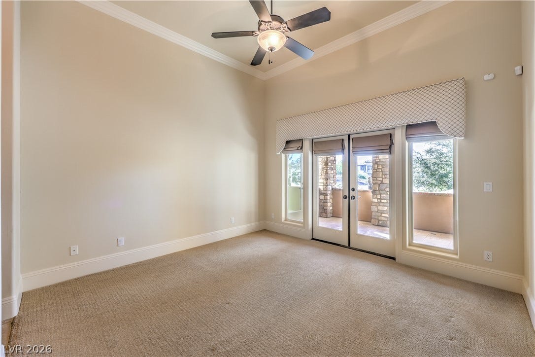 16 Anthem Pointe Court, Henderson, NV 89052 Crown molding and glass doors leading outside define this comfortable space.
