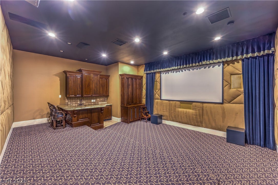 16 Anthem Pointe Court, Henderson, NV 89052 Patterned carpeting and built-in cabinetry define this private home theater room.