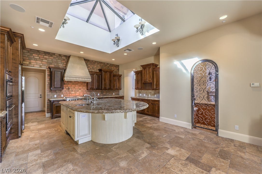 16 Anthem Pointe Court, Henderson, NV 89052 Natural light floods this kitchen through a large central skylight illuminating the stone details.