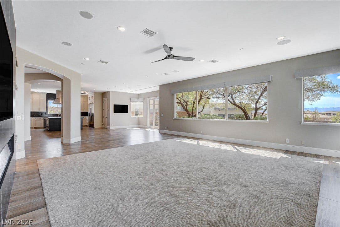 84 Kittansett Loop, Henderson, NV 89052 An open floorplan connects the spacious living area to the kitchen through arched transitions.