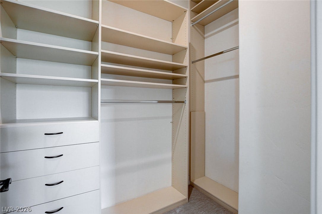 84 Kittansett Loop, Henderson, NV 89052 Custom built-in shelving and ample hanging space define this functional closet organization system.