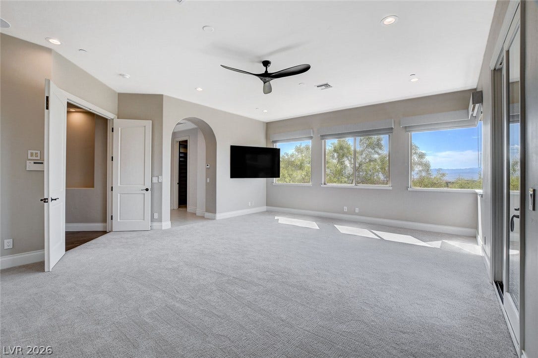 84 Kittansett Loop, Henderson, NV 89052 Sunlight streams across the soft carpeting through large windows framing scenic outdoor views.