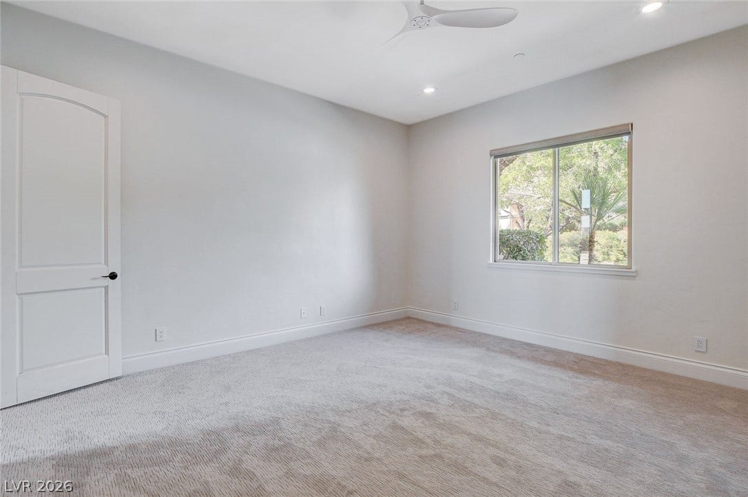 84 Kittansett Loop, Henderson, NV 89052 Plush carpeting and recessed lighting create a comfortable atmosphere in this peaceful bedroom.