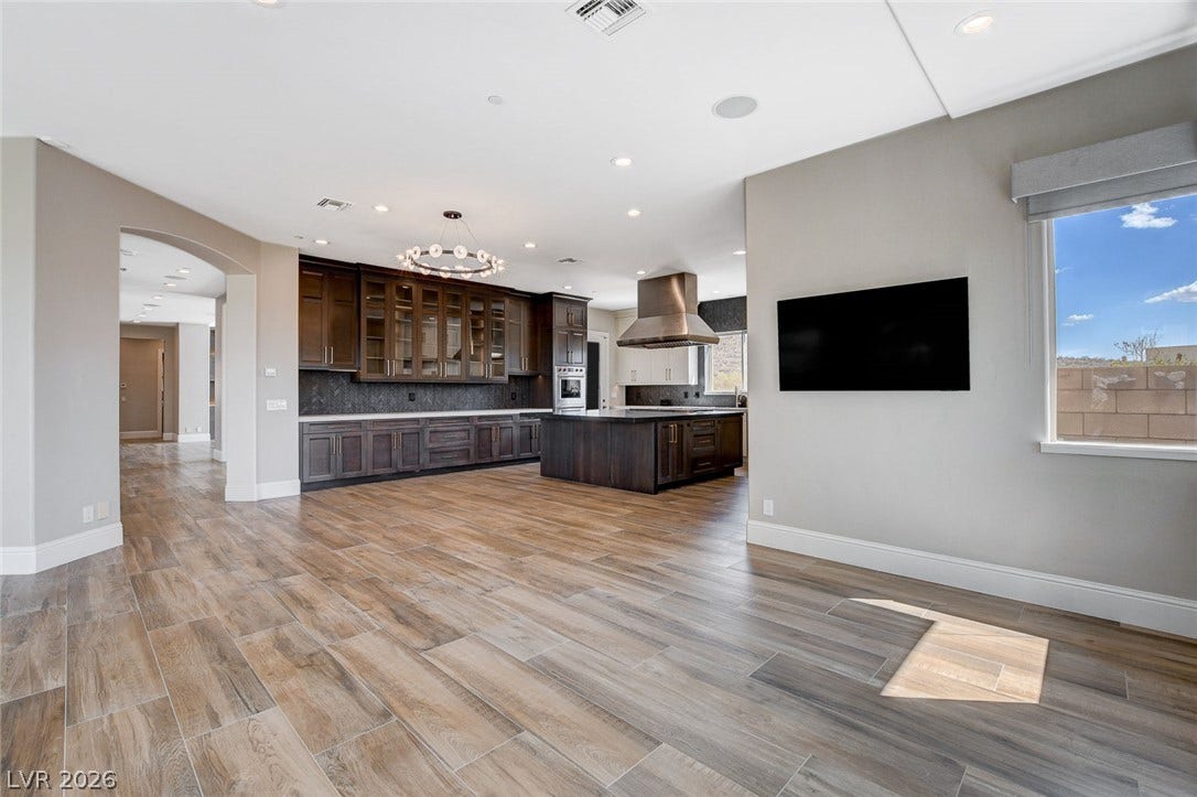 84 Kittansett Loop, Henderson, NV 89052 Warm wood-look tile flooring flows throughout this modern kitchen and open-concept living space.