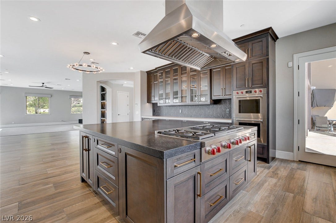 84 Kittansett Loop, Henderson, NV 89052 A spacious central island Anchors this modern kitchen, seamlessly connecting to an open living space.