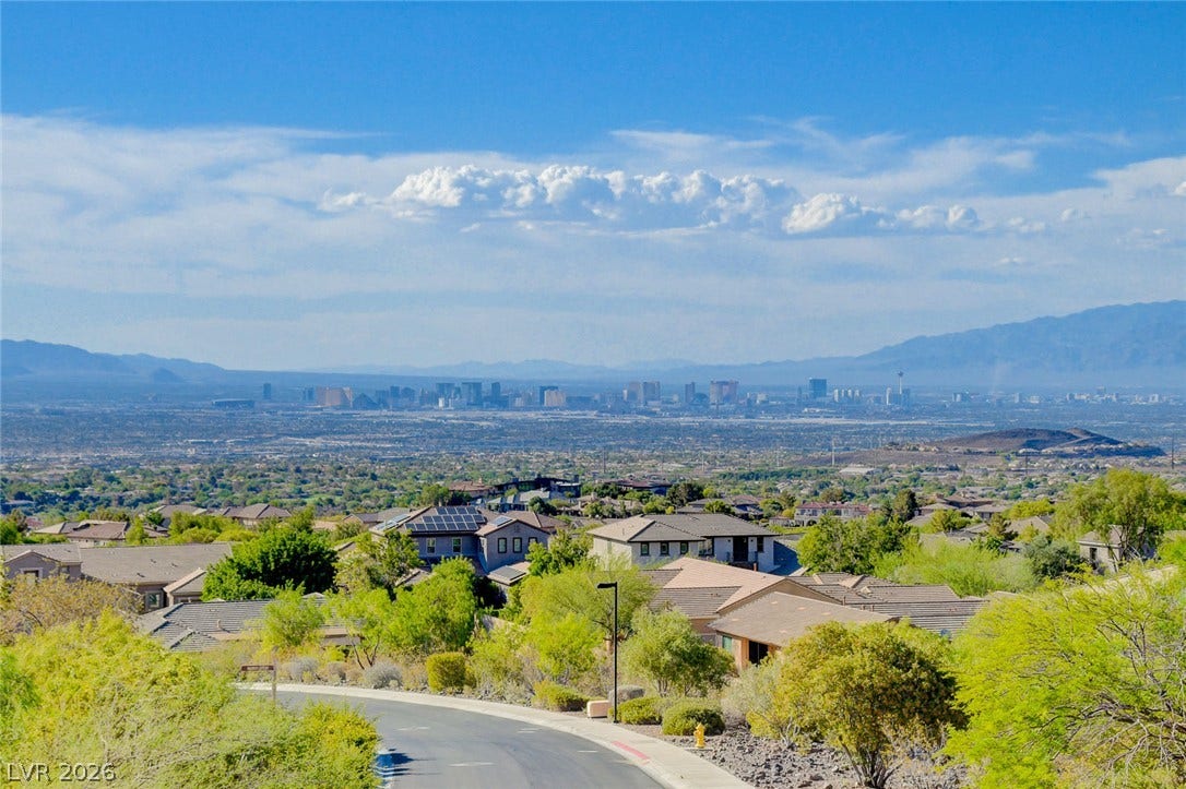 84 Kittansett Loop, Henderson, NV 89052 Panoramas of the distant city skyline unfold from this elevated neighborhood vantage point.