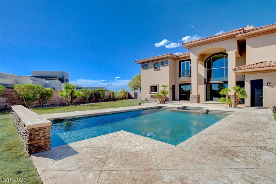 84 Kittansett Loop, Henderson, NV 89052 A pristine swimming pool anchors the backyard of this grand Mediterranean-style estate.