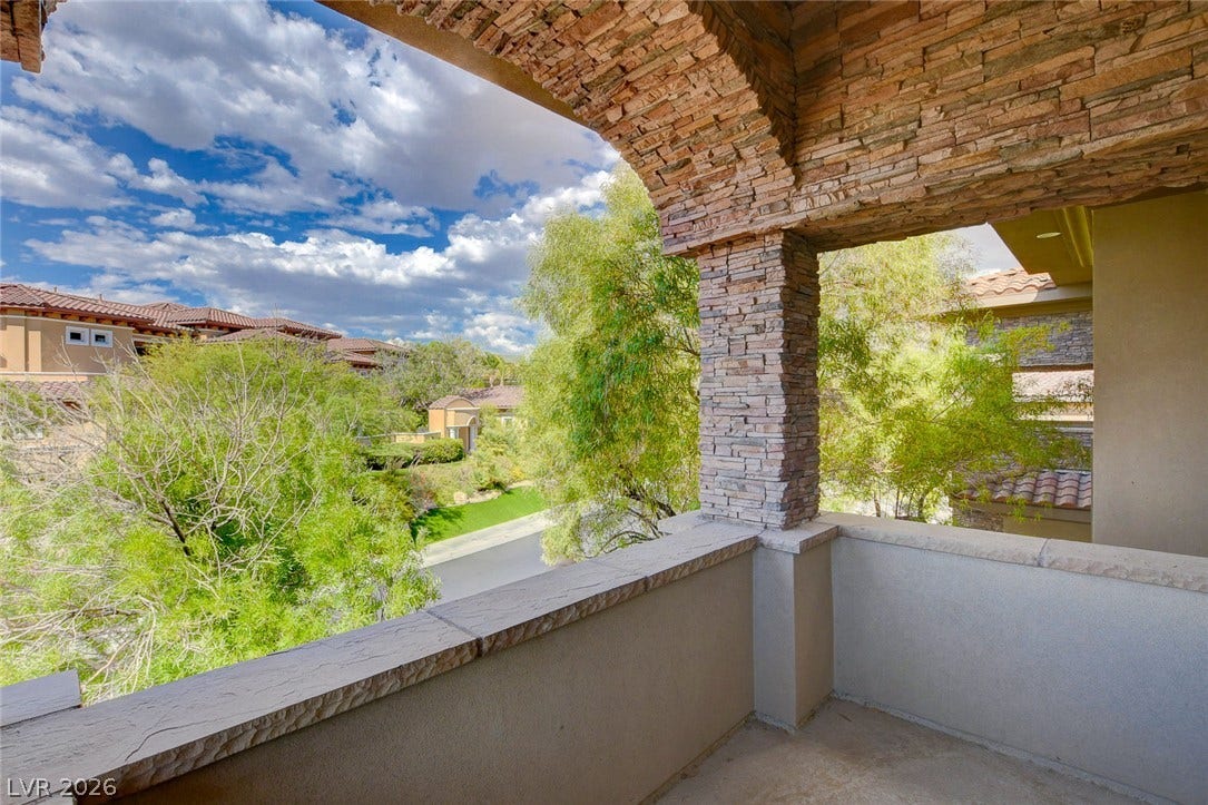 84 Kittansett Loop, Henderson, NV 89052 Stone columns frame elevated neighborhood views from this private covered balcony.