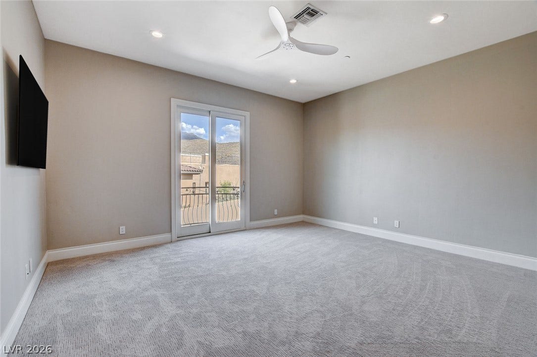84 Kittansett Loop, Henderson, NV 89052 Plush carpeting and sliding glass doors defining a serene, comfortable atmosphere.