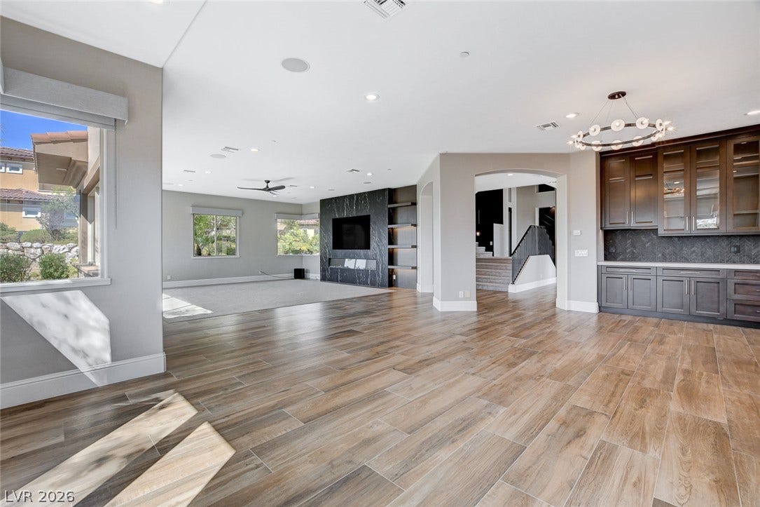 84 Kittansett Loop, Henderson, NV 89052 Plank tile flooring and recessed lighting define this open-concept main living space.