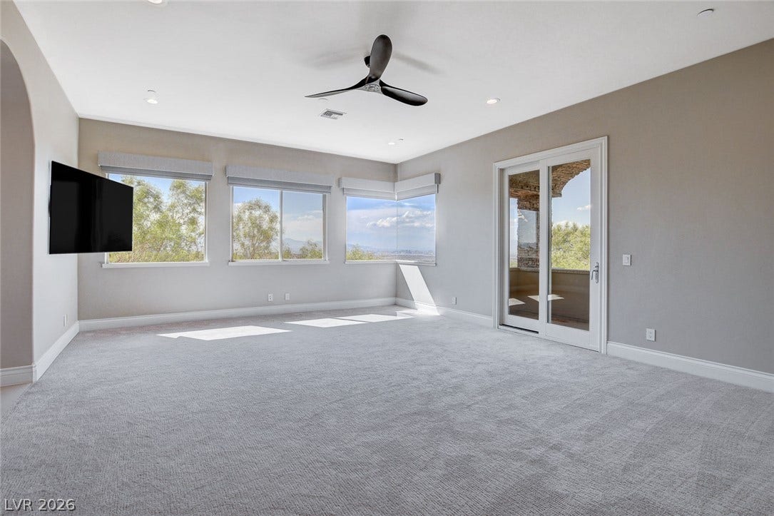 84 Kittansett Loop, Henderson, NV 89052 Plush carpeting and wide sliding doors anchor this versatile, light-filled interior space.