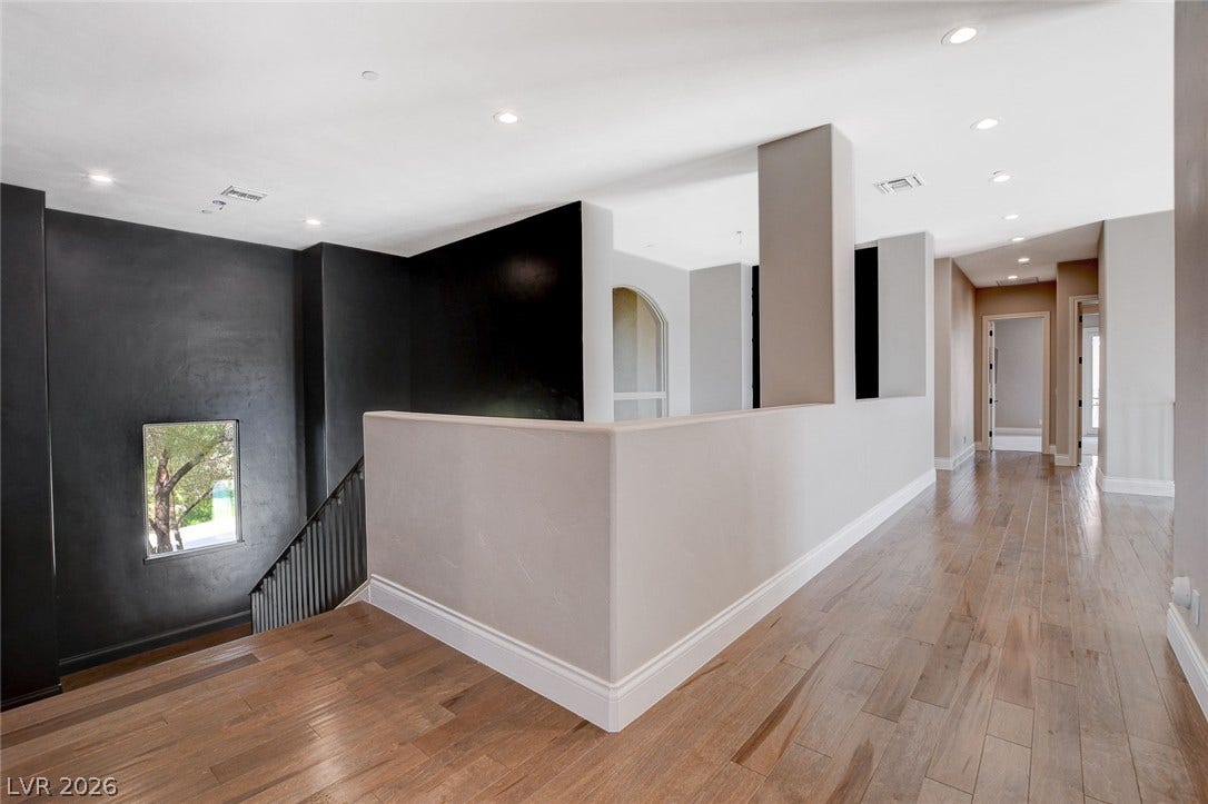 84 Kittansett Loop, Henderson, NV 89052 Rich wood flooring runs throughout this spacious upper landing featuring clean architectural lines.