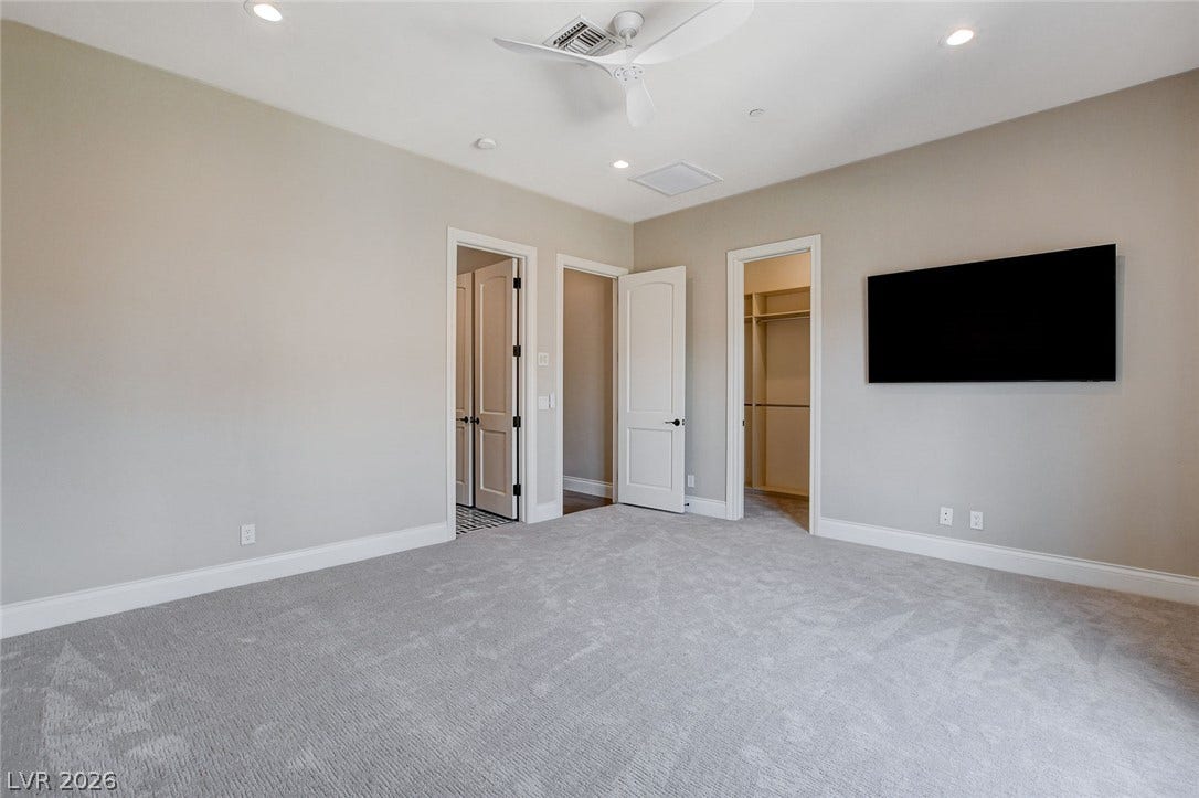 84 Kittansett Loop, Henderson, NV 89052 Recessed lighting and soft carpeting create a serene and inviting atmosphere in this bedroom.