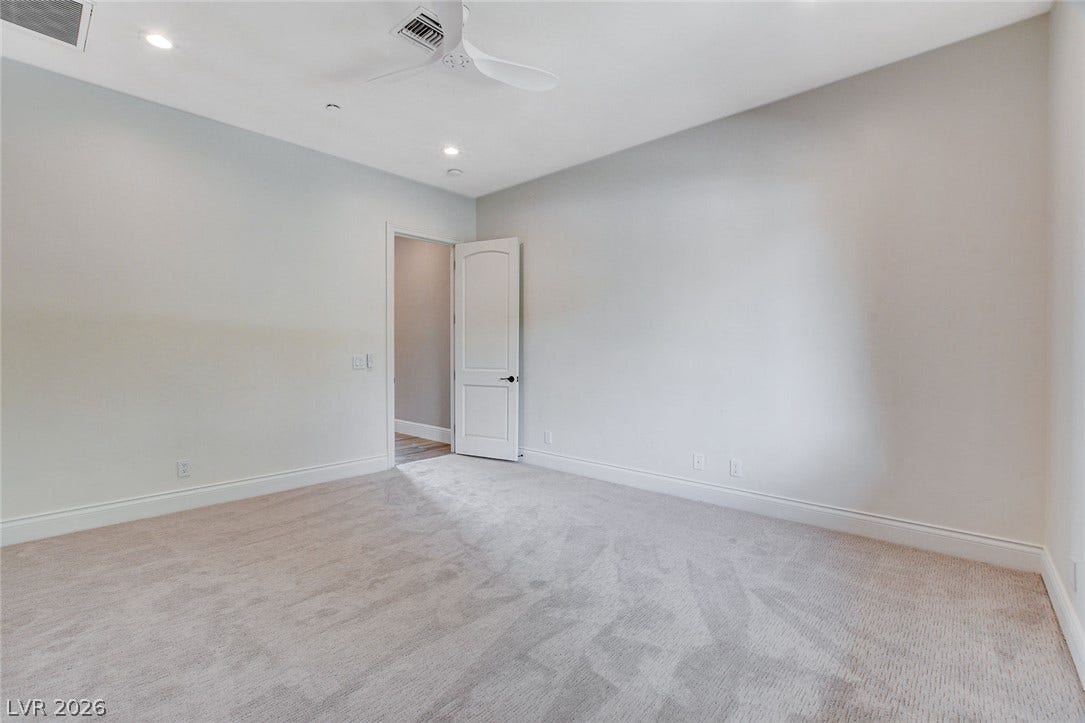 84 Kittansett Loop, Henderson, NV 89052 Plush carpeting and recessed lighting define this serene and versatile bedroom space.
