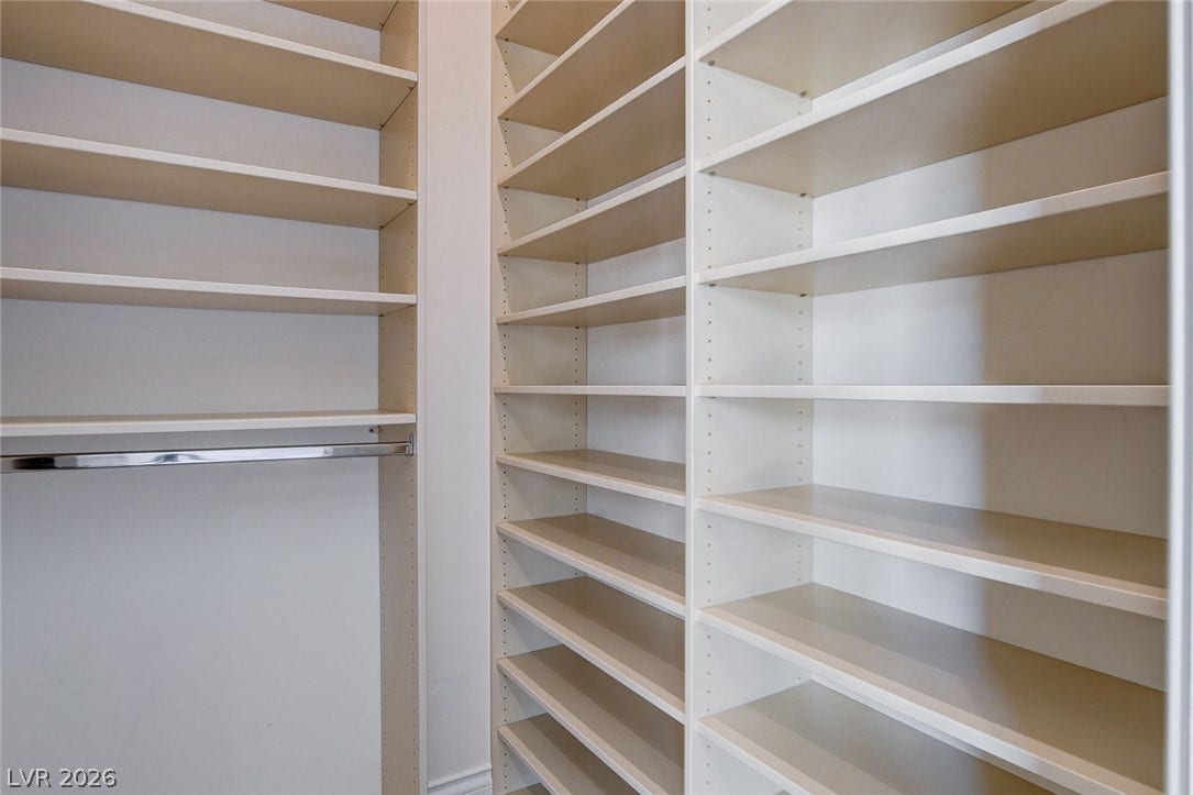 84 Kittansett Loop, Henderson, NV 89052 Floor-to-ceiling built-in shelving maximizes storage space within this organized walk-in closet.
