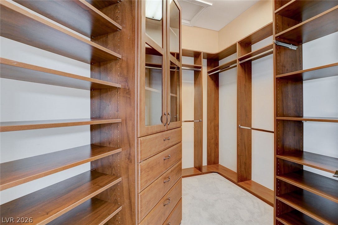 84 Kittansett Loop, Henderson, NV 89052 Rich wood shelving and built-in drawers maximize storage in this spacious walk-in closet.
