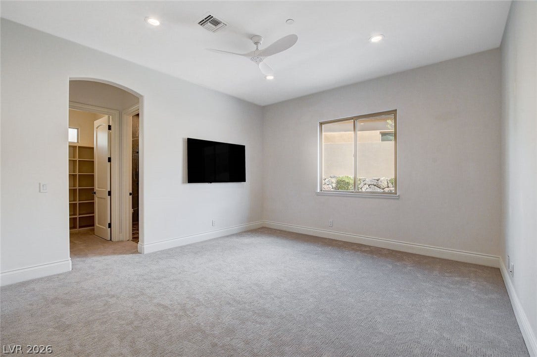 84 Kittansett Loop, Henderson, NV 89052 Soft carpeting pairs with recessed lighting in a serene, neutral-toned bedroom layout.