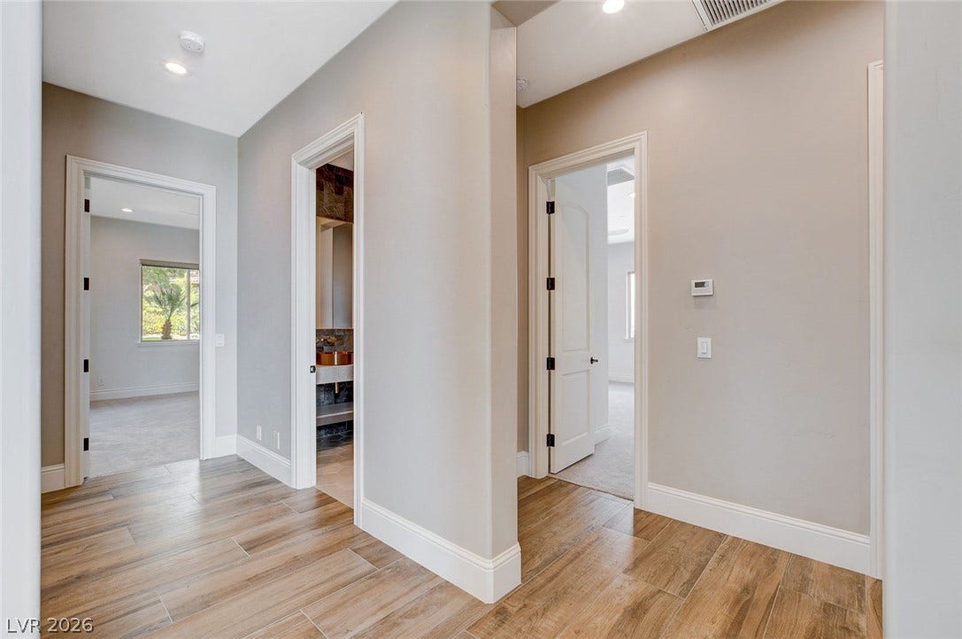 84 Kittansett Loop, Henderson, NV 89052 Gleaming wood floors guide the way through this centrally located hallway.