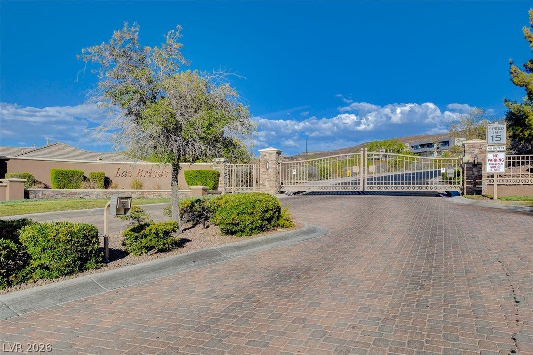 84 Kittansett Loop, Henderson, NV 89052 Secure gated entry welcomes residents with stone pillars and professional landscaping.