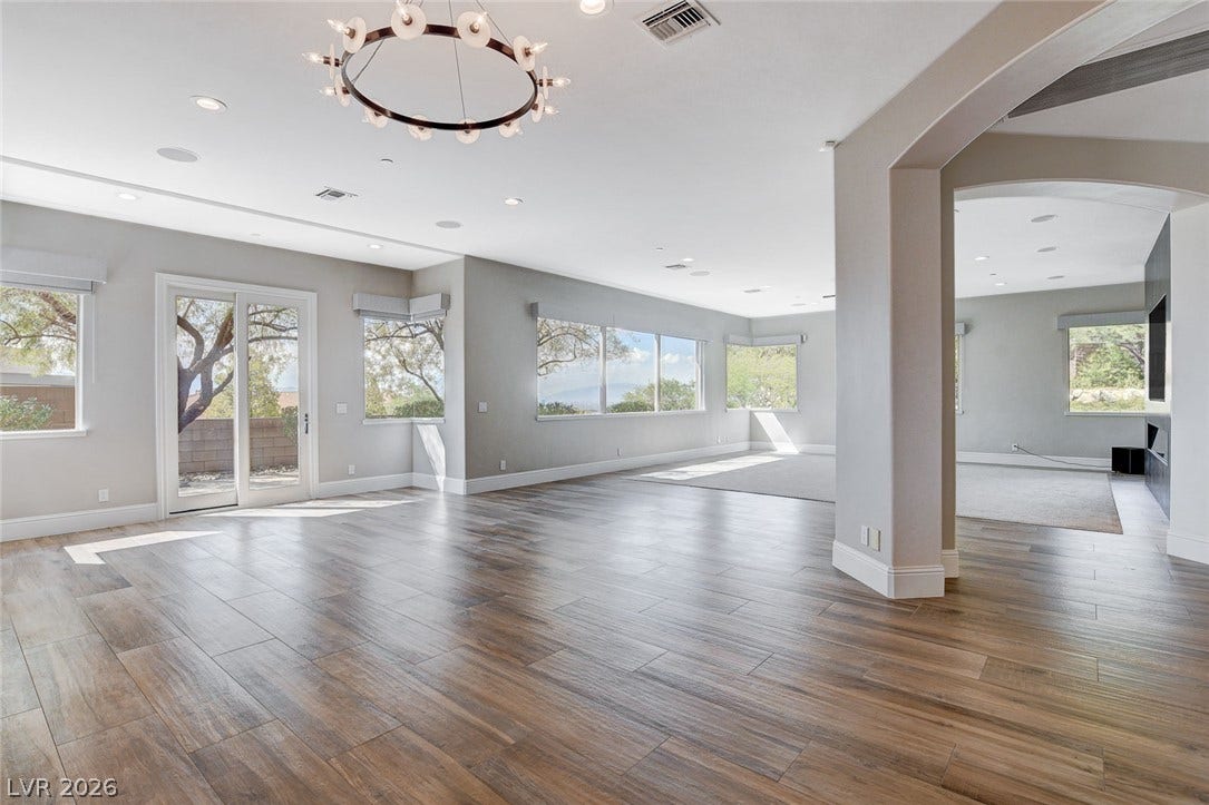 84 Kittansett Loop, Henderson, NV 89052 Gleaming wood-look floors anchor a sprawling, light-filled layout framed by tall windows.