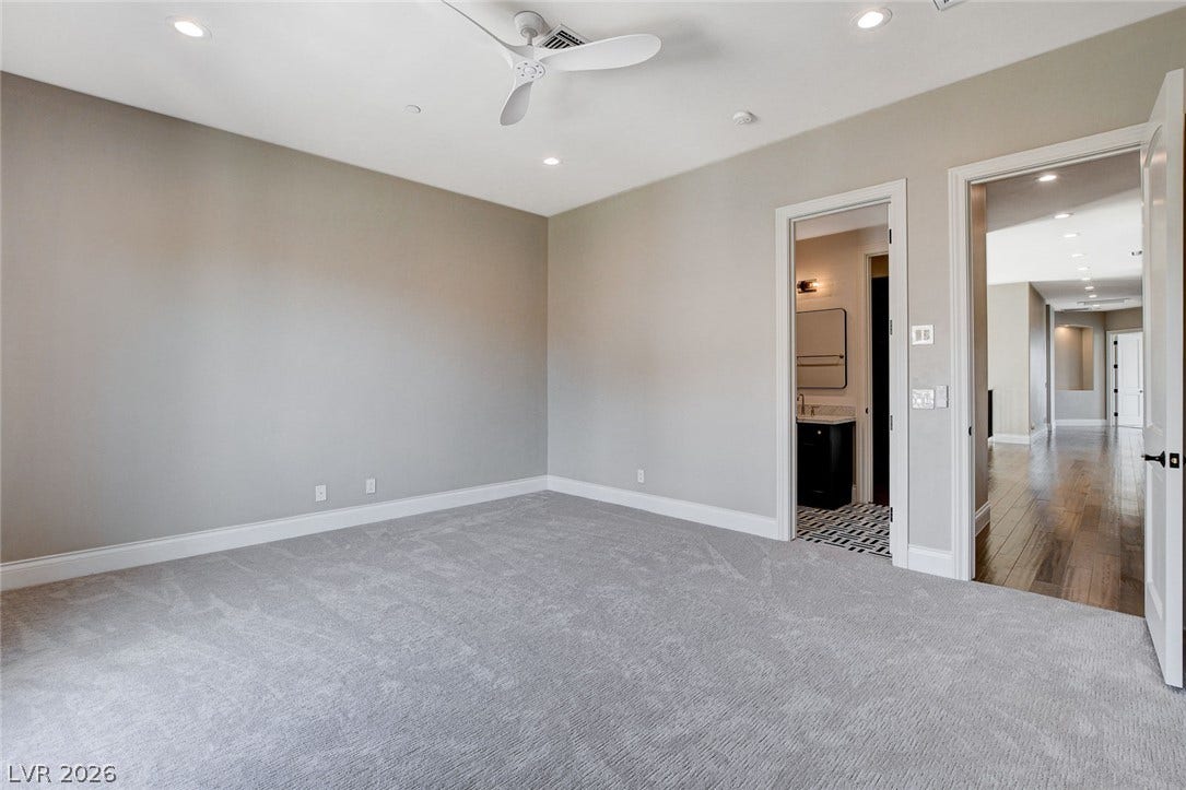 84 Kittansett Loop, Henderson, NV 89052 Soft carpeting pairs with recessed lighting in a comfortable bedroom suite with direct bathroom access.