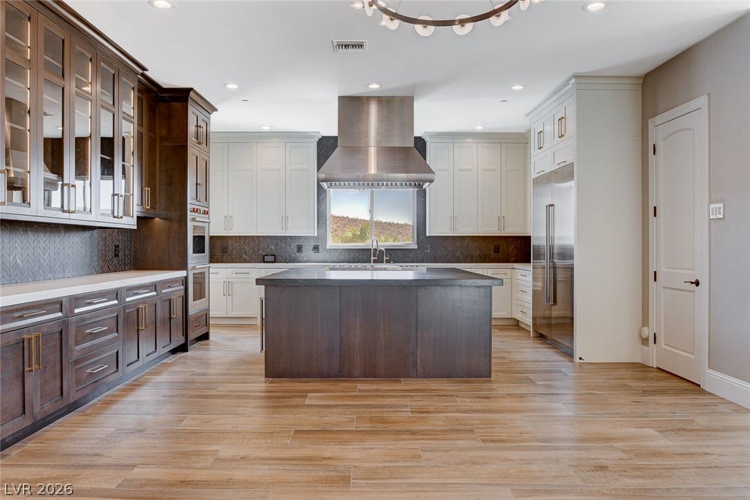 84 Kittansett Loop, Henderson, NV 89052 Warm wood flooring meets dual-tone cabinetry and a central prep island in this culinary space.