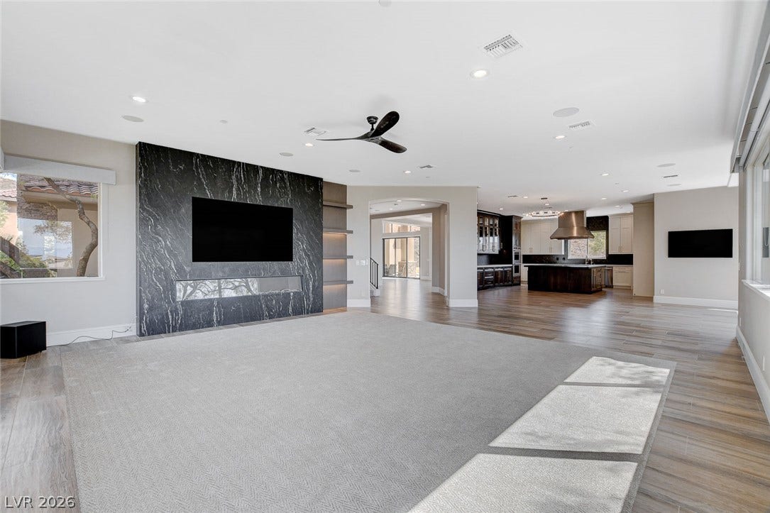 84 Kittansett Loop, Henderson, NV 89052 Clean lines and a striking stone fireplace wall define this open living space.