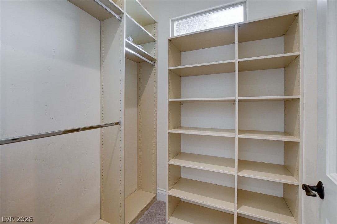 84 Kittansett Loop, Henderson, NV 89052 A window brings natural light into this walk-in closet with built-in shelving.