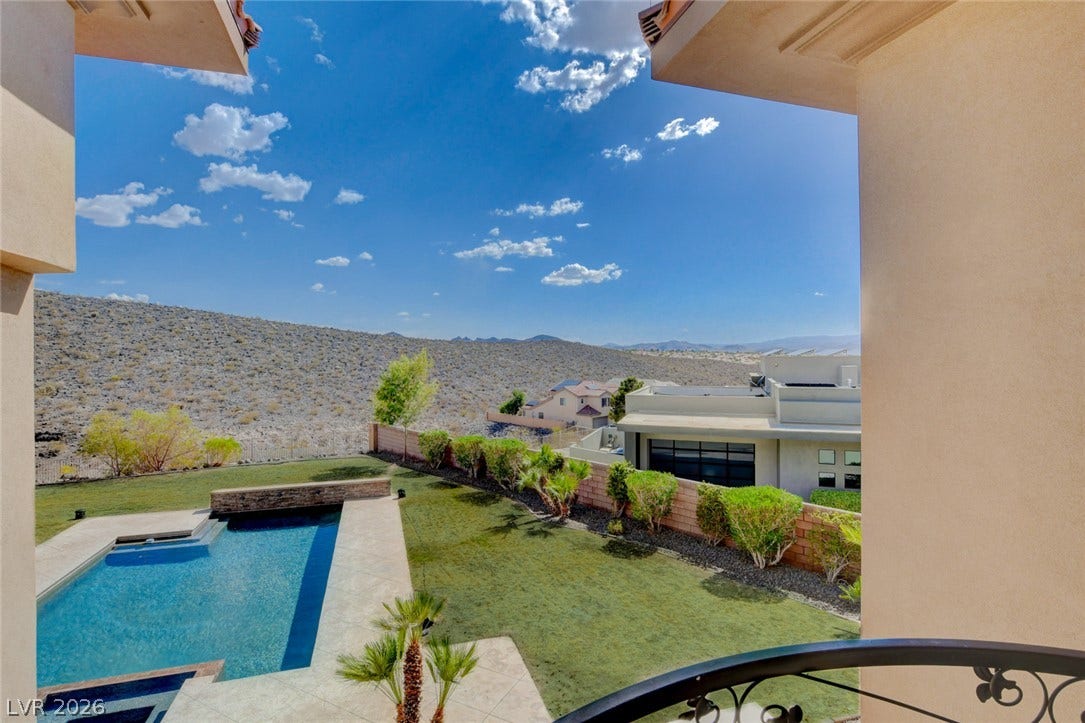 84 Kittansett Loop, Henderson, NV 89052 Expansive desert vistas and rolling hills frame the private backyard oasis below.