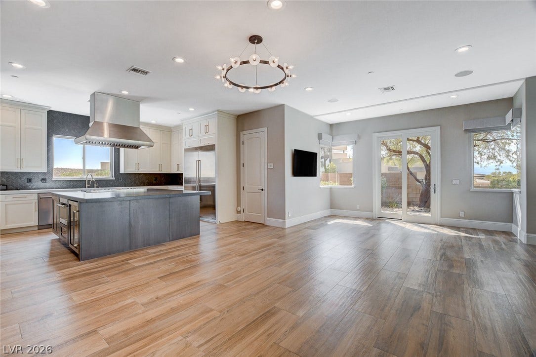 84 Kittansett Loop, Henderson, NV 89052 An open-concept living area flows into a modern kitchen with a large center island.
