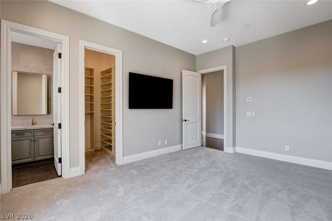 84 Kittansett Loop, Henderson, NV 89052 Plush carpeting and high ceilings define this versatile bedroom suite with an attached bath.