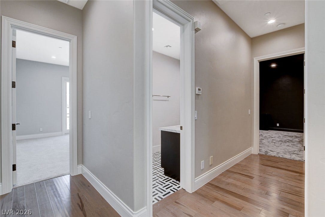 84 Kittansett Loop, Henderson, NV 89052 Gleaming hardwood floors run throughout a central hallway connecting several bedrooms and baths.