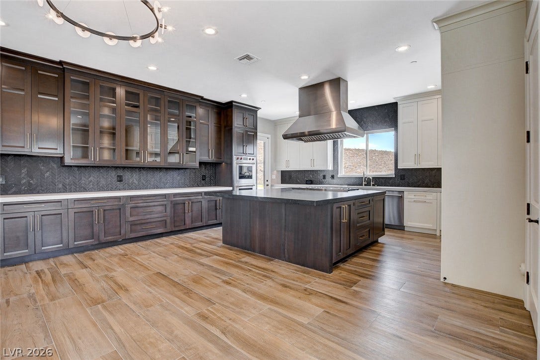 84 Kittansett Loop, Henderson, NV 89052 Gleaming wood-look tile floors anchor a generous kitchen equipped with a massive central island.