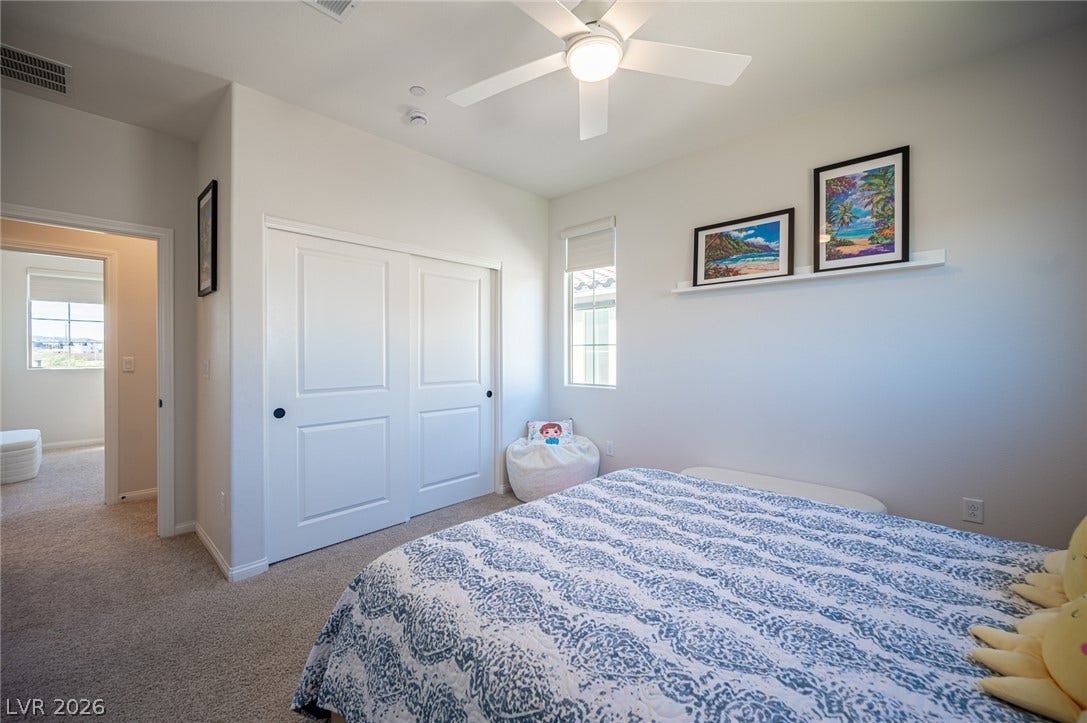 320 Della Pergola Place, Henderson, NV 89015 A quiet bedroom features plush carpeting and a large sliding closet.
