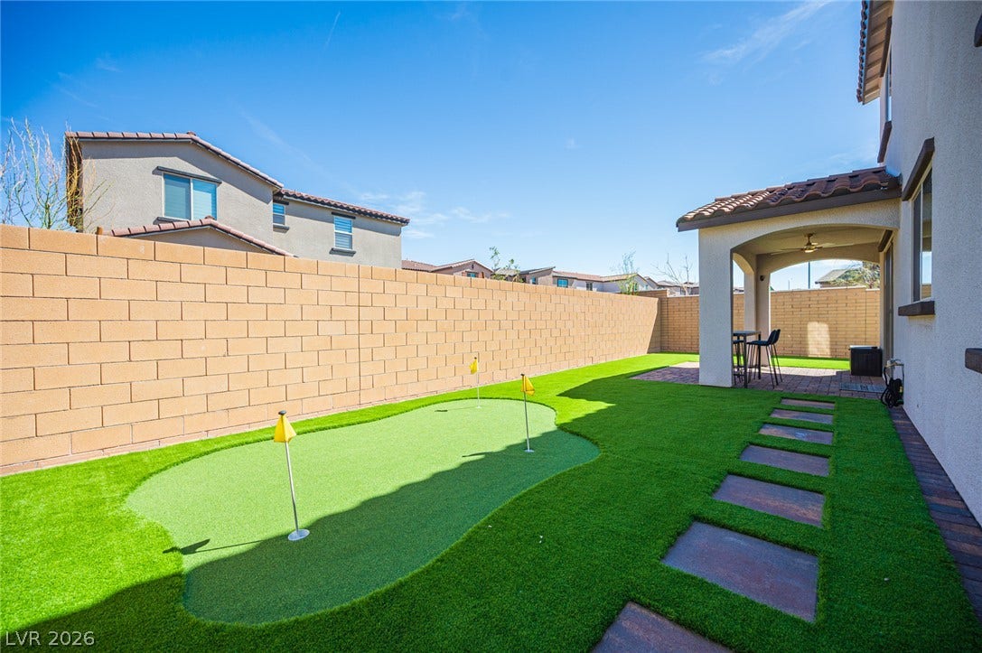 320 Della Pergola Place, Henderson, NV 89015 An manicured putting green highlights this private outdoor space framed by a secure block wall.
