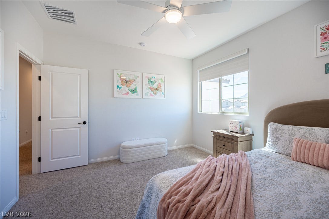 320 Della Pergola Place, Henderson, NV 89015 Plush carpeting and a multi-pane window create a comfortable, sunlit atmosphere in this bedroom.