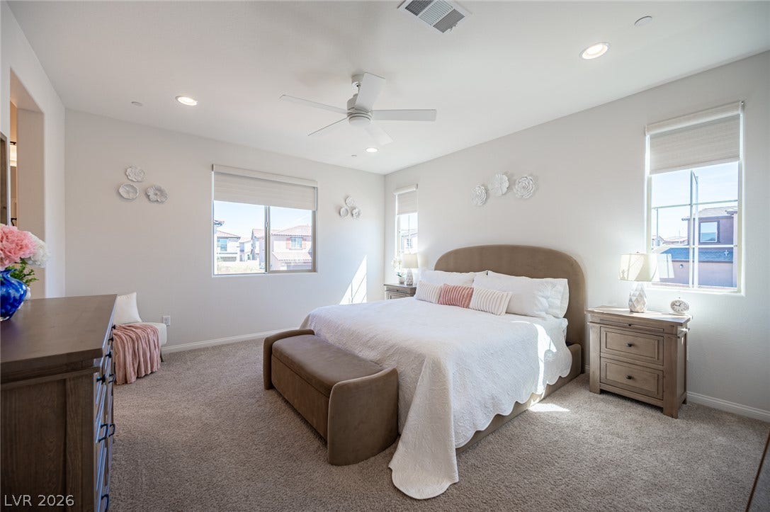 320 Della Pergola Place, Henderson, NV 89015 Plentiful windows fill this bedroom with natural light while illuminating the soft carpeting.