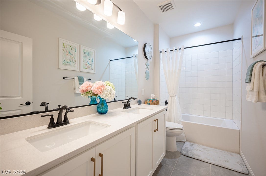 320 Della Pergola Place, Henderson, NV 89015 Clean lines and a spacious dual vanity define this classic, light-filled bathroom.