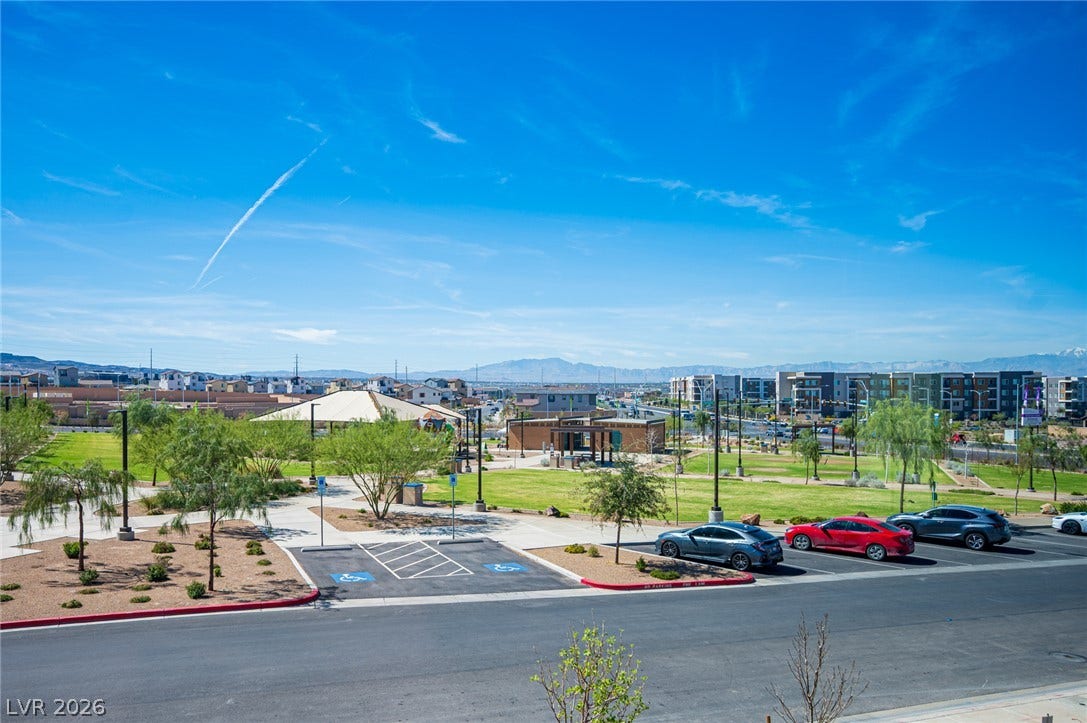 320 Della Pergola Place, Henderson, NV 89015 Distant mountain ranges frame the expansive green community park visible from this vantage point.