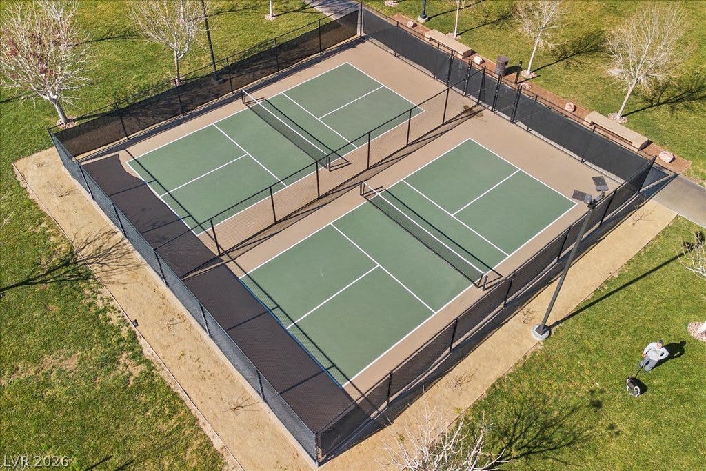 320 Della Pergola Place, Henderson, NV 89015 Fenced sports courts sit nestled among green lawns and mature trees in this community space.