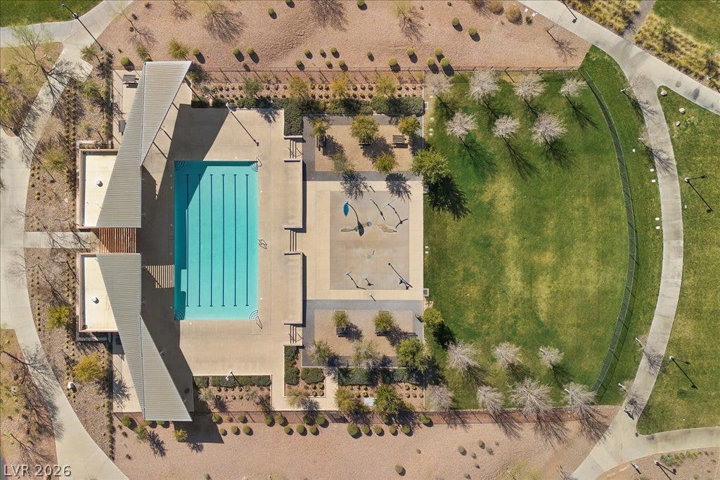 320 Della Pergola Place, Henderson, NV 89015 An aerial perspective showcases a sparkling community swimming pool beside a manicured grassy park.