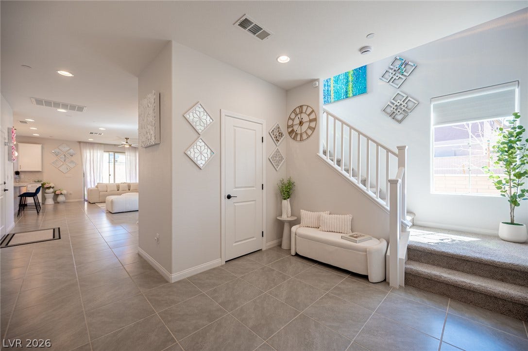 320 Della Pergola Place, Henderson, NV 89015 An inviting entryway presents neutral tile flooring and stairs leading to the upper level.