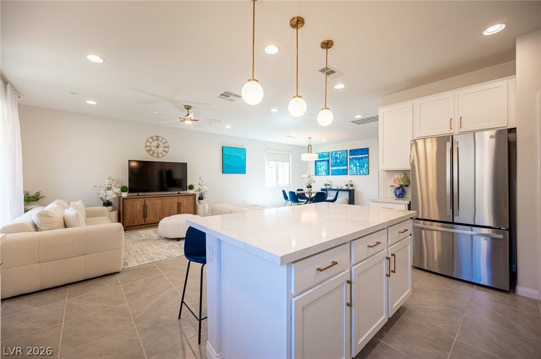 320 Della Pergola Place, Henderson, NV 89015 An open floorplan connects the modern kitchen with the comfortable living area.