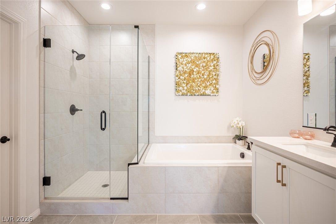 320 Della Pergola Place, Henderson, NV 89015 A glass-enclosed shower alongside a deep soaking tub creates a spa-like retreat.