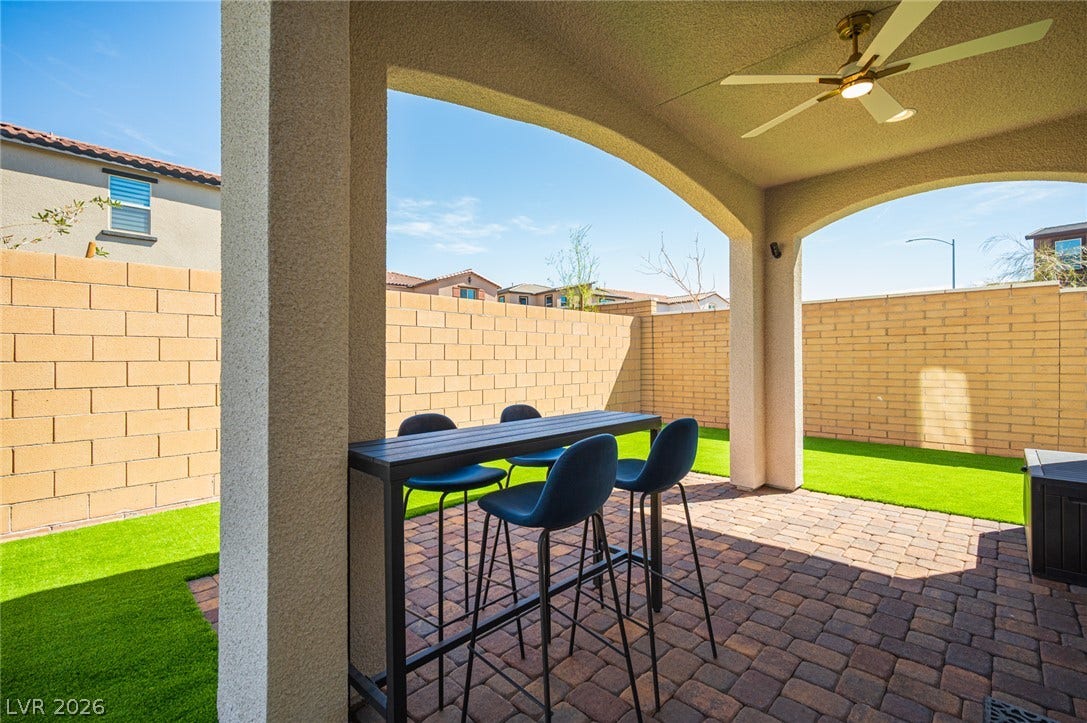 320 Della Pergola Place, Henderson, NV 89015 An arched covered patio with block paving overlooks a private fenced yard.