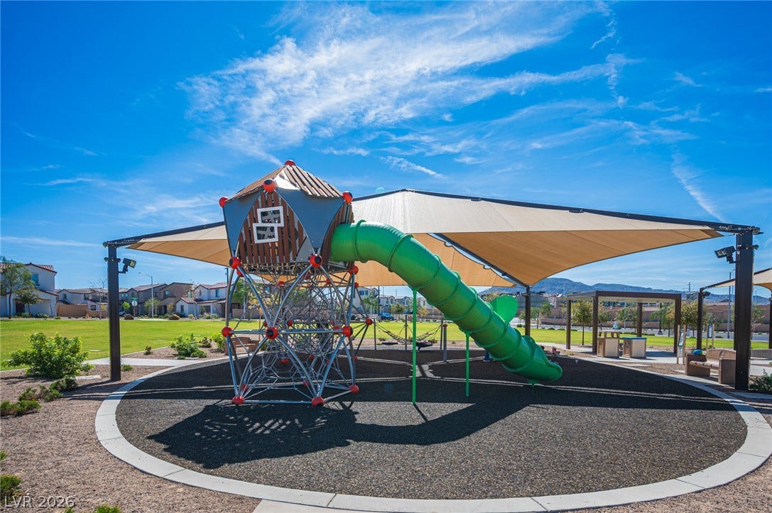 320 Della Pergola Place, Henderson, NV 89015 Shaded play structures and climbing equipment stand ready for outdoor recreation in the neighborhood park.