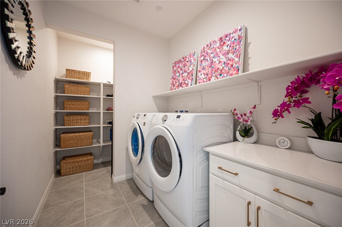 320 Della Pergola Place, Henderson, NV 89015 A spacious laundry room features clean tile flooring and extensive built-in shelving.