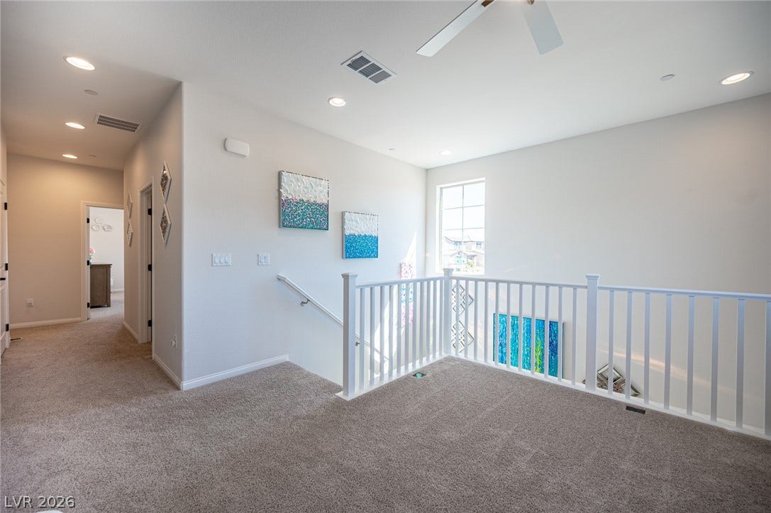 320 Della Pergola Place, Henderson, NV 89015 Plush carpeting underfoot defines this airy upper landing featuring recessed lighting and clean architectural lines.