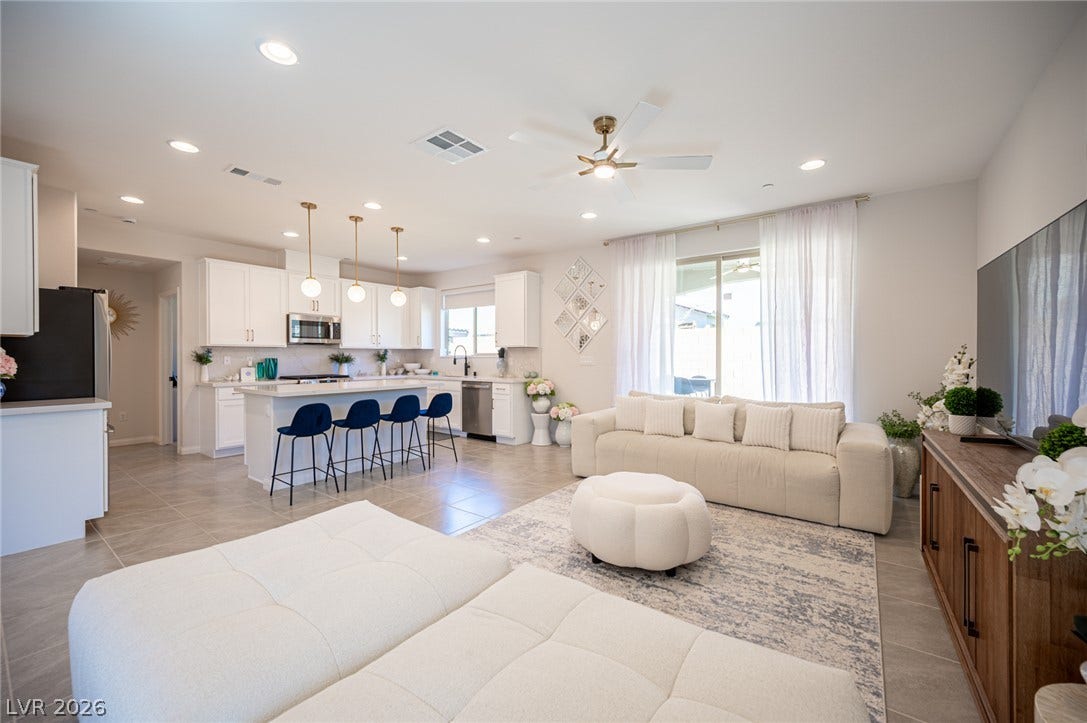320 Della Pergola Place, Henderson, NV 89015 An open floor plan seamlessly connects a modern kitchen to a bright living space.